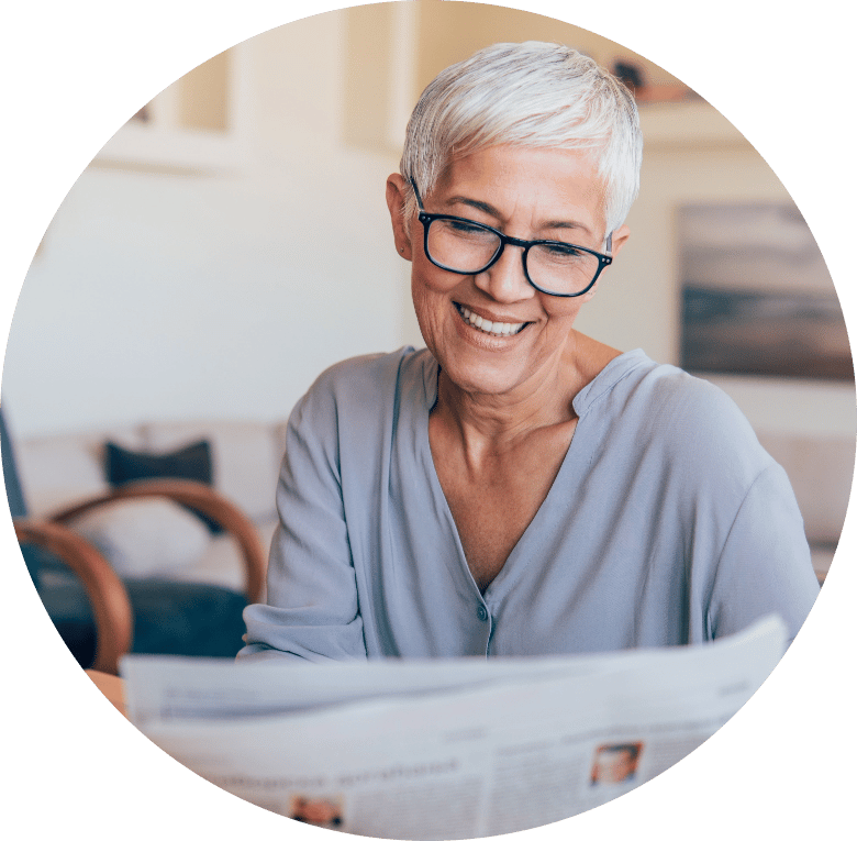 Mature woman smiling reading the news paper in Melbourne, FL
