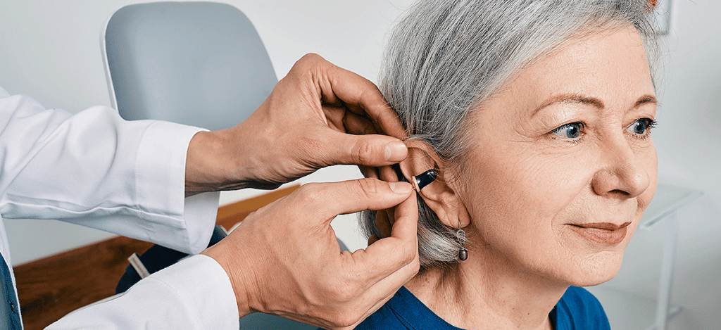Woman getting fitted with hearing aids in Melbourne, FL