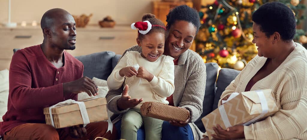 Festive family opening presents with hearing health in mind during the holidays