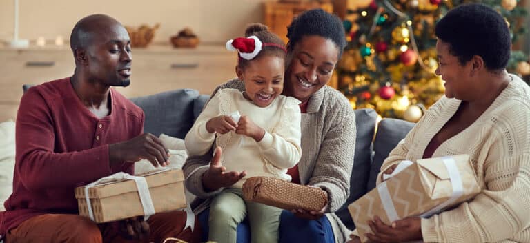 Festive family opening presents with hearing health in mind during the holidays